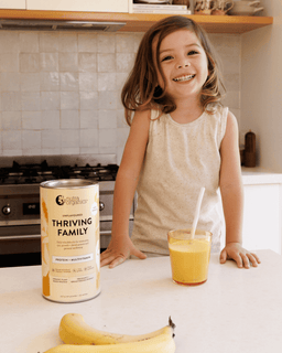 Child with banana smoothie made with Thriving Family Unflavoured